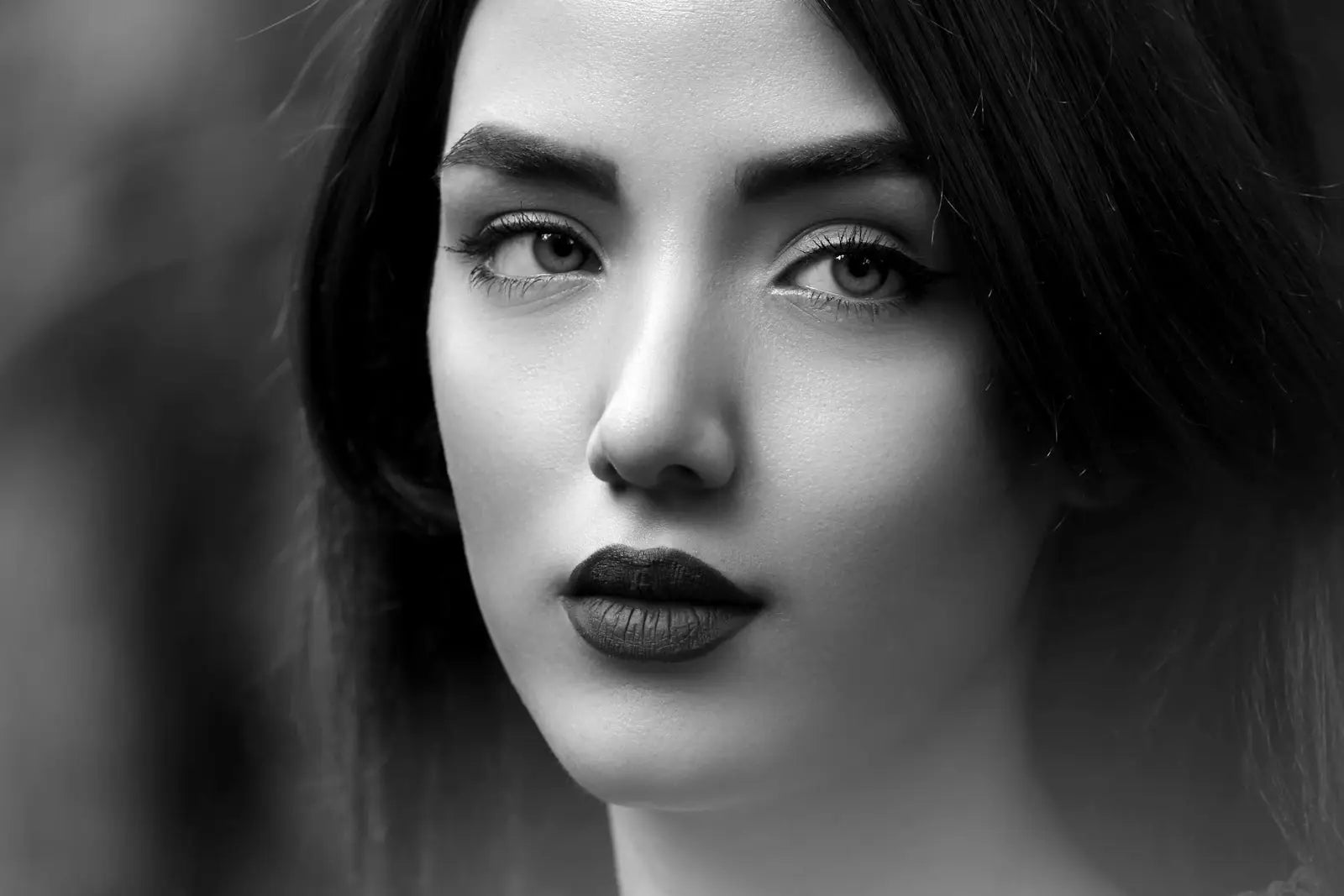 woman with black hair and pink lipstick