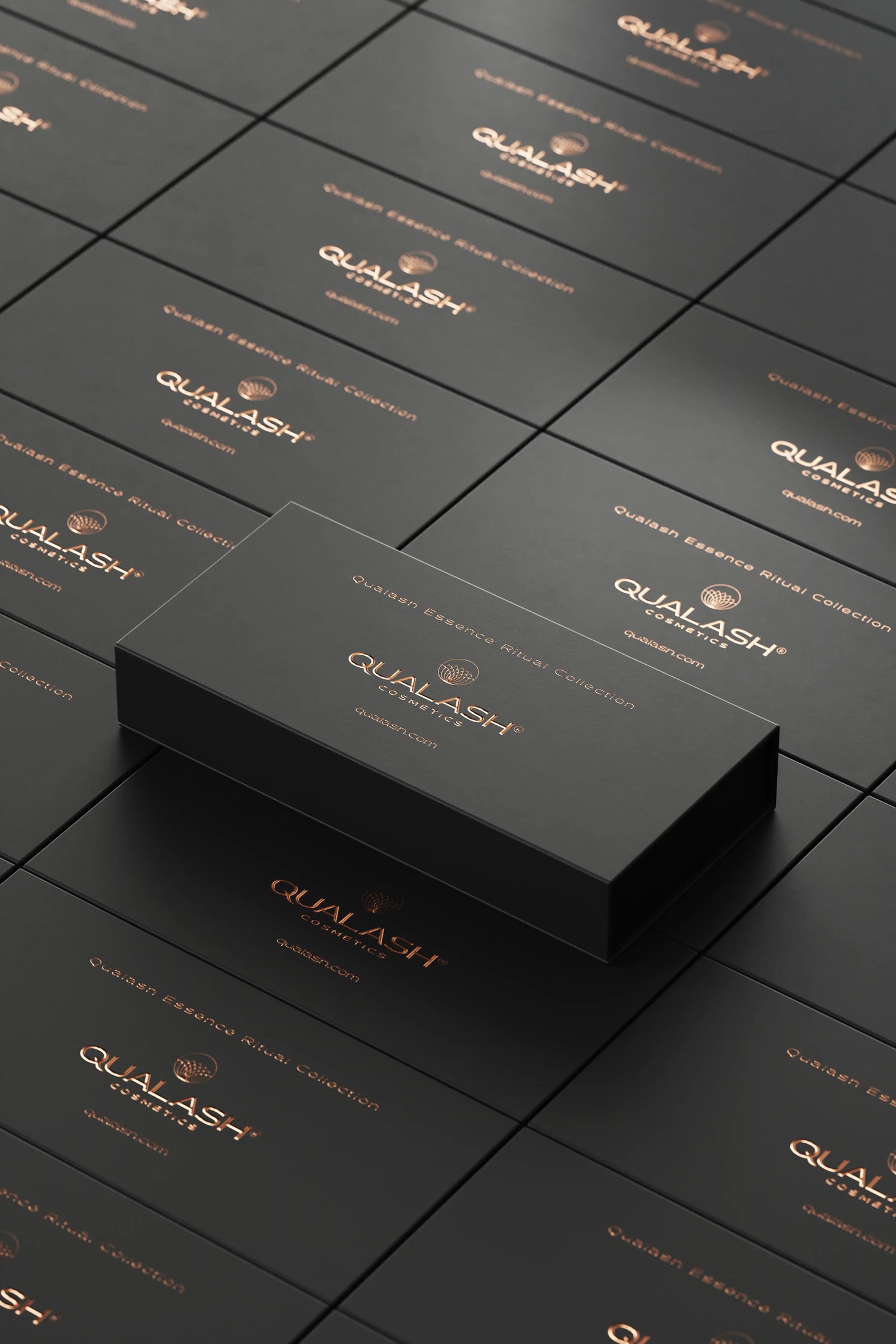 Stacked black QUALASH Collection boxes with copper logo – high-end product presentation.